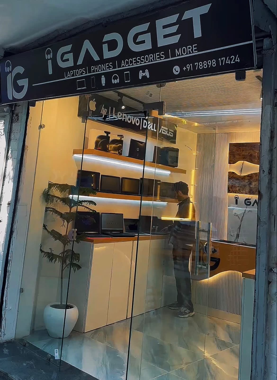 The iGadget shop front on Babar Lane, Main Market, Kupwara, with laptops on lit shelves inside